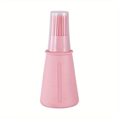 Pink bottle with brush attachment on a white background