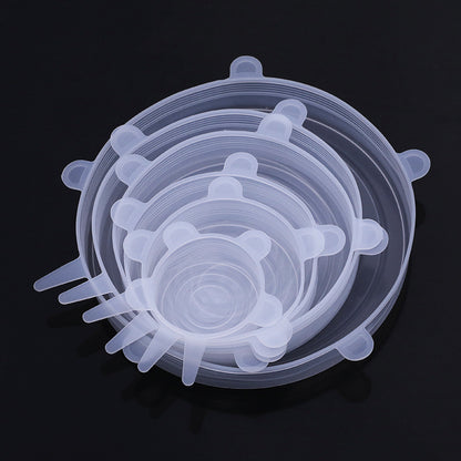 Stack of clear silicone lids on a black background