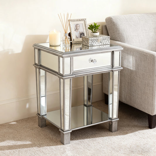 Silver mirrored side table with decorative items in a living room setting