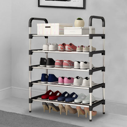 Multi-tiered shoe rack with various shoes on a gray floor against a white wall.