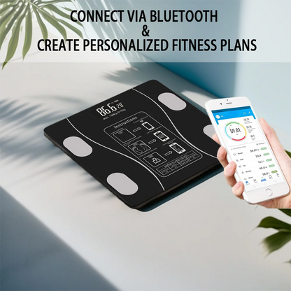 Black digital fitness scale with smartphone app on a light surface