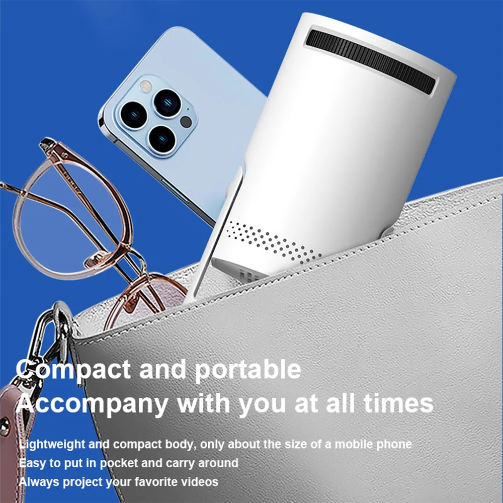 Small projector in a bag with a phone and glasses, against a blue background
