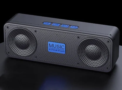 Black Bluetooth speaker with blue LED indicators on a dark background