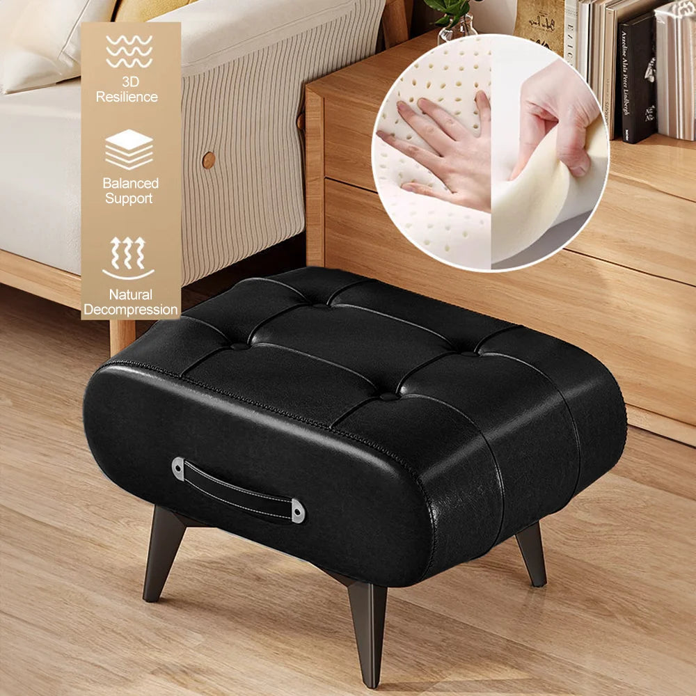 Black leather ottoman on a wooden floor with a close-up of its cushioned surface.