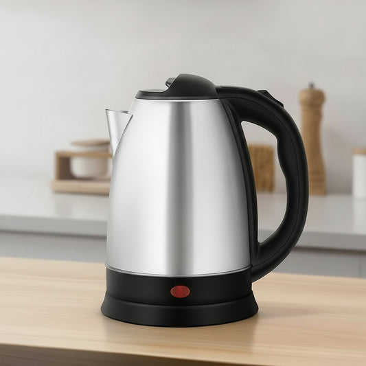 Electric kettle on a kitchen counter with glasses of water and a 'real shot' label.
