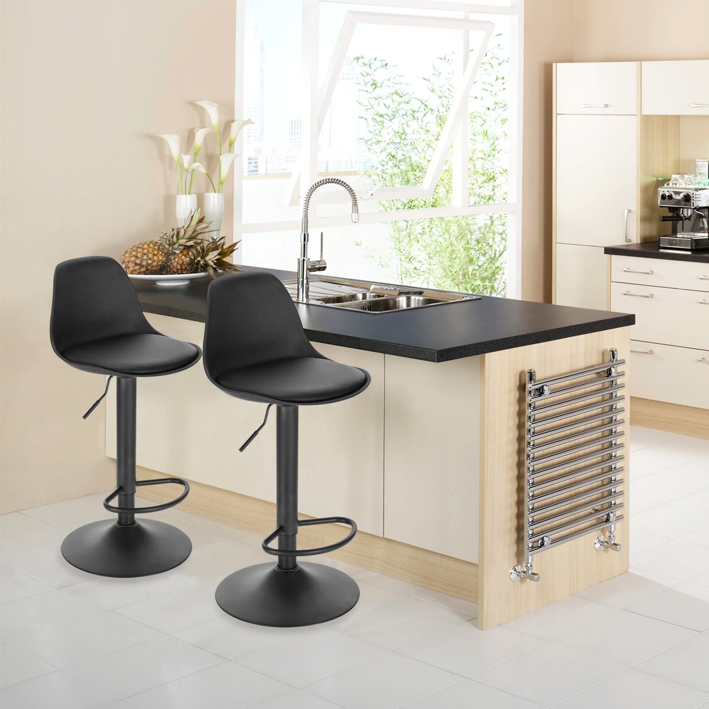 Modern kitchen with black bar stools and a stainless steel radiator.