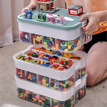 Stackable toy storage bins filled with colorful building blocks, held by a person.