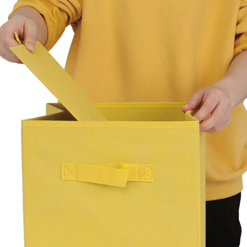 Person holding a yellow fabric storage box with a matching label.