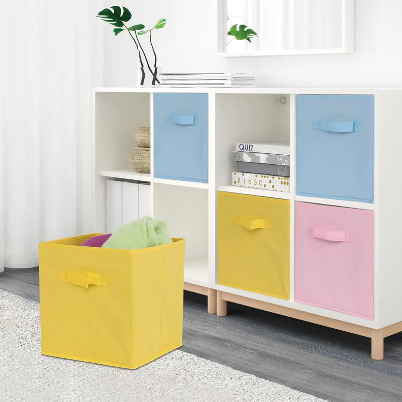 Colorful storage boxes in front of a white shelving unit with blue, yellow, and pink boxes.