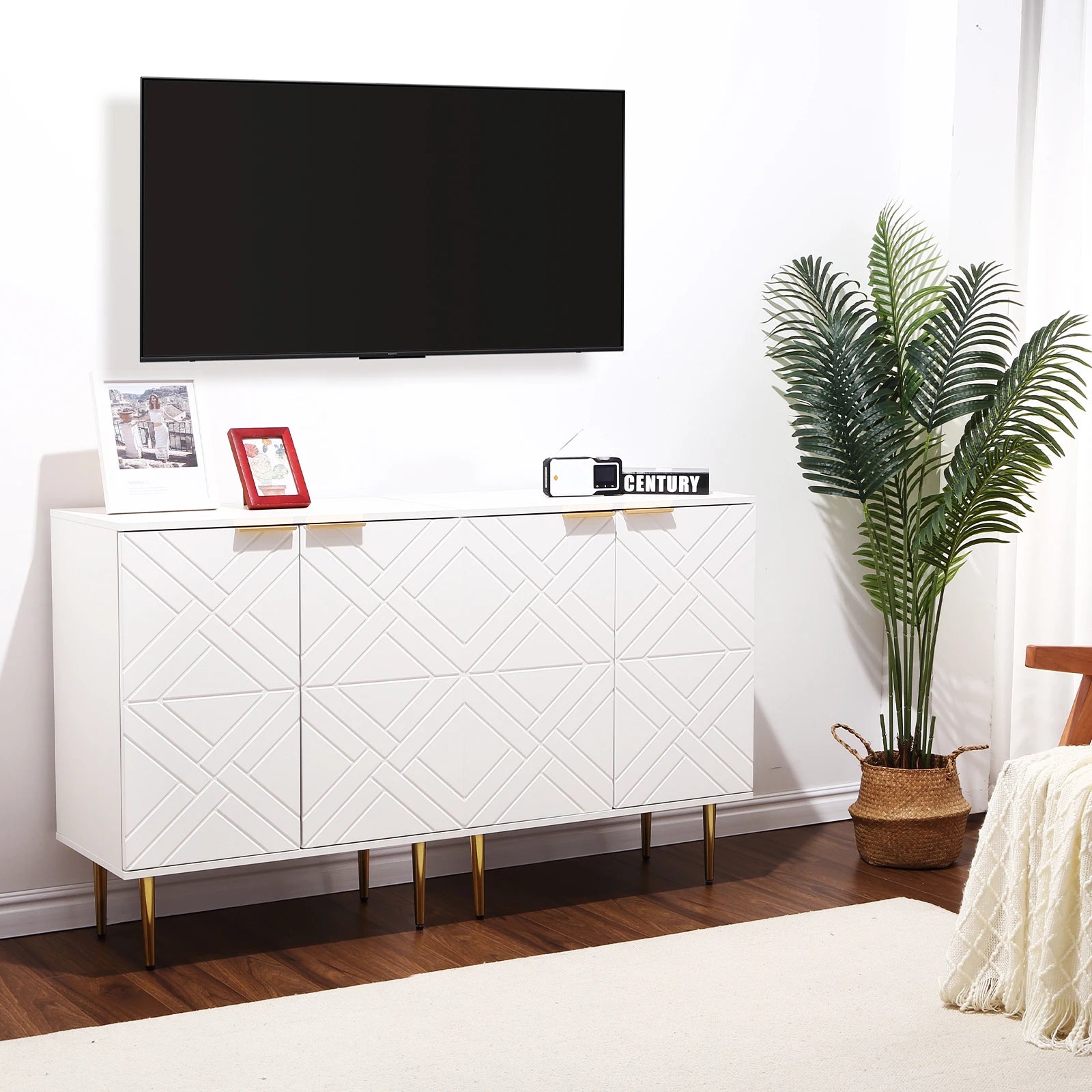 White entertainment console with a TV above it in a living room setting.