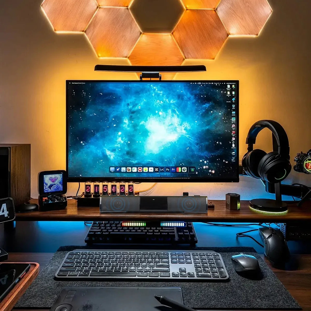 Modern home office setup with a large monitor, keyboard, mouse, and headphones on a desk.