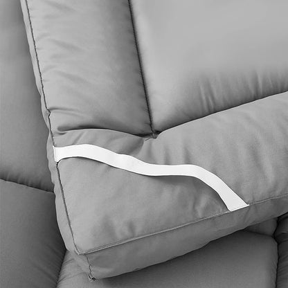 Gray sofa with a white strap detail on a neutral background