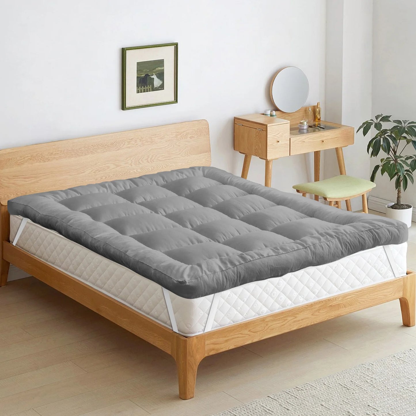 Gray mattress topper on a wooden bed in a bedroom setting.