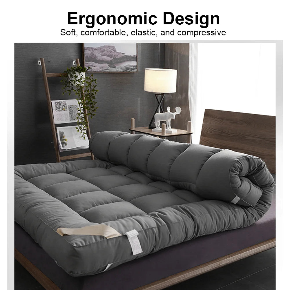 Gray mattress topper on a bed with room decor in the background