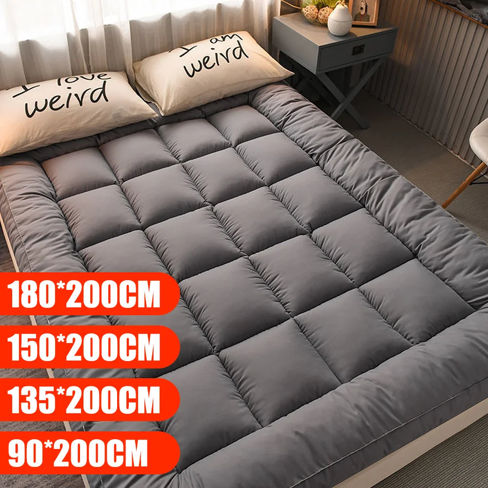 Gray mattress topper on a bed with size options displayed