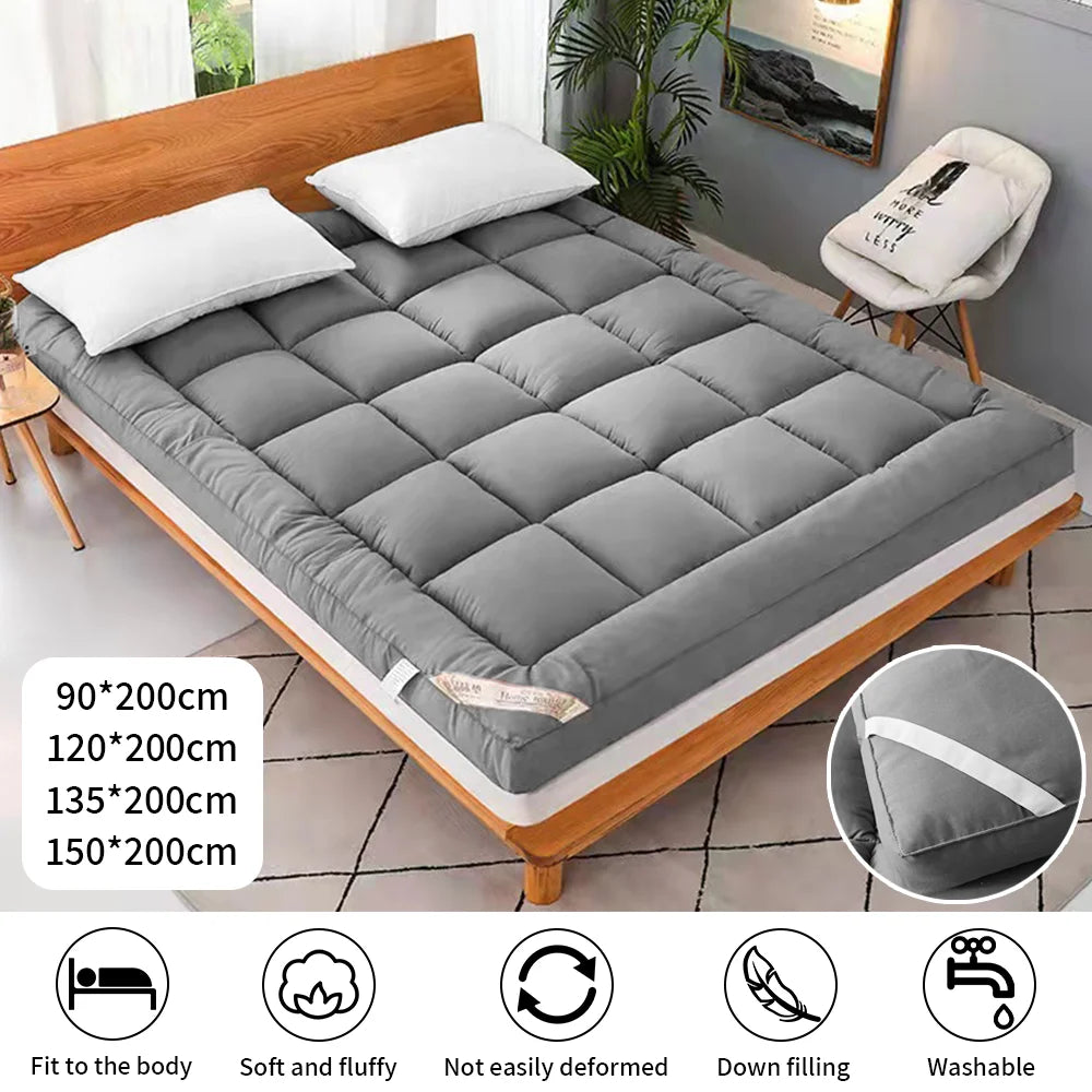 Gray mattress topper on a wooden bed frame with room decor.