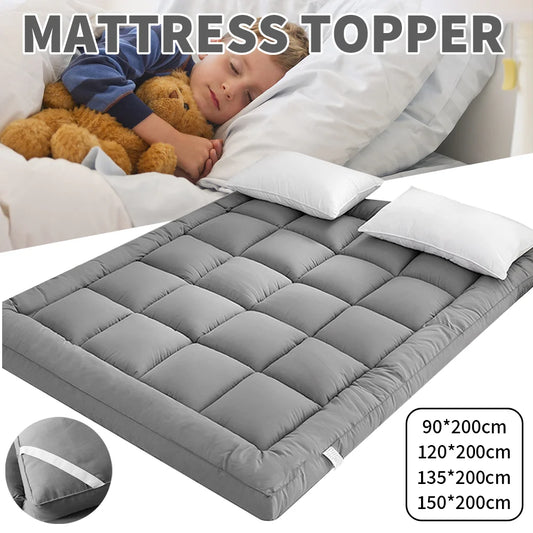 Gray mattress topper on a bed with a child and teddy bear, showing product dimensions.