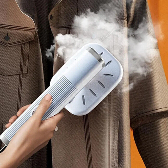 Person using a steam cleaner on a jacket against an orange background