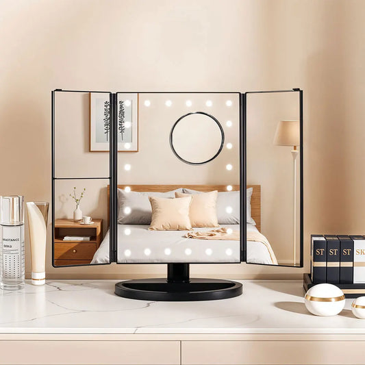 Foldable vanity mirror with lights on a countertop in a bedroom setting