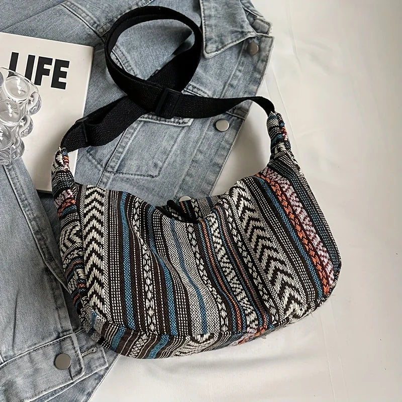 Patterned shoulder bag on a denim jacket with a magazine underneath