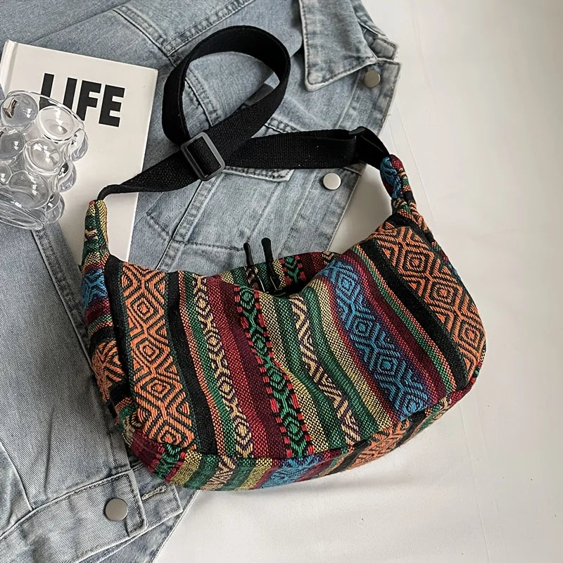 Colorful patterned bag on a denim jacket with a magazine underneath