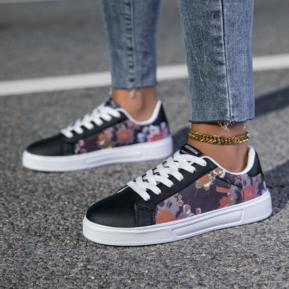 Black sneakers with floral pattern worn on a street