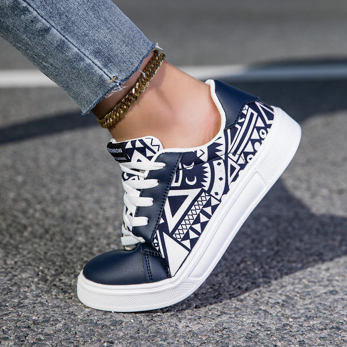 Navy blue and white patterned sneaker on a pavement background