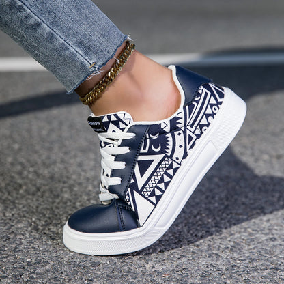Navy blue and white patterned sneaker on a pavement background