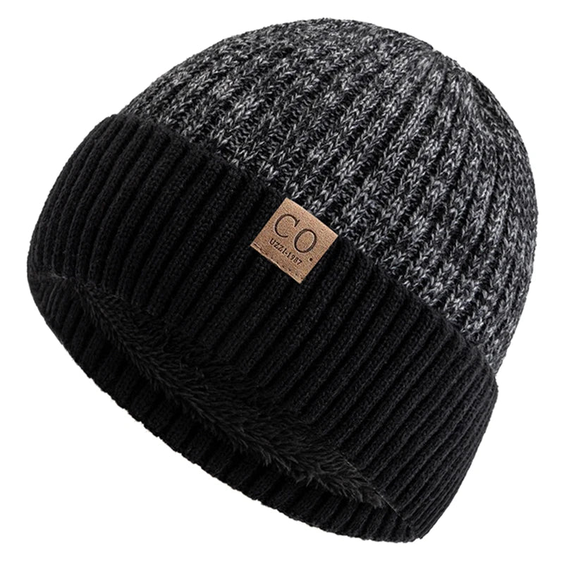 Two-tone black and gray knit beanie with a brand label on a white background