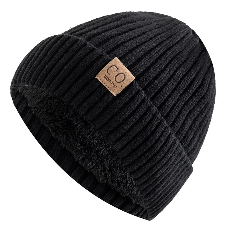 Black ribbed beanie with a brown label on a white background