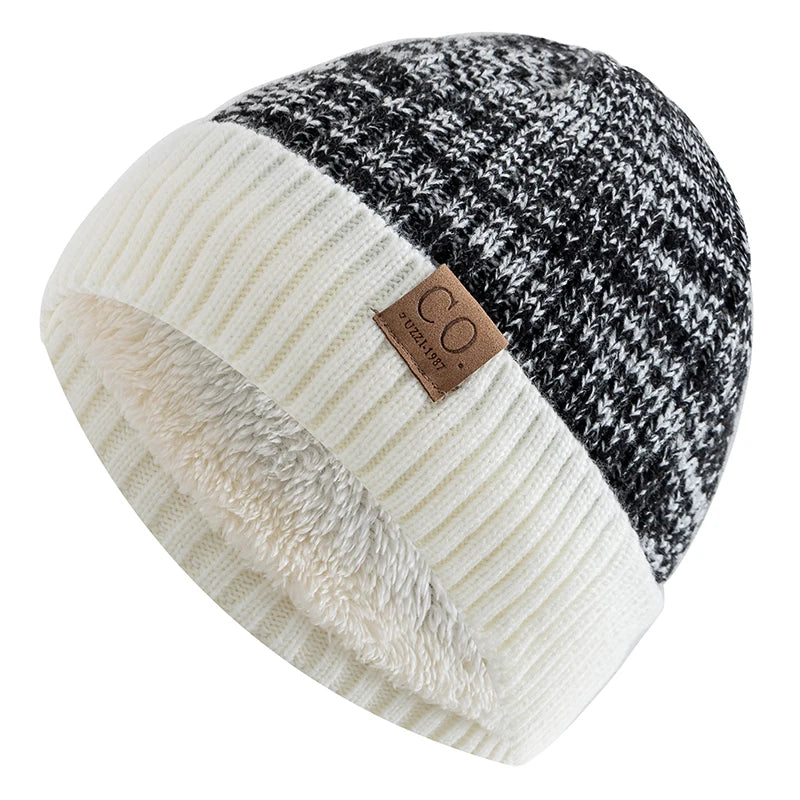 Two-tone knit beanie with checkered pattern and brown label on a white background