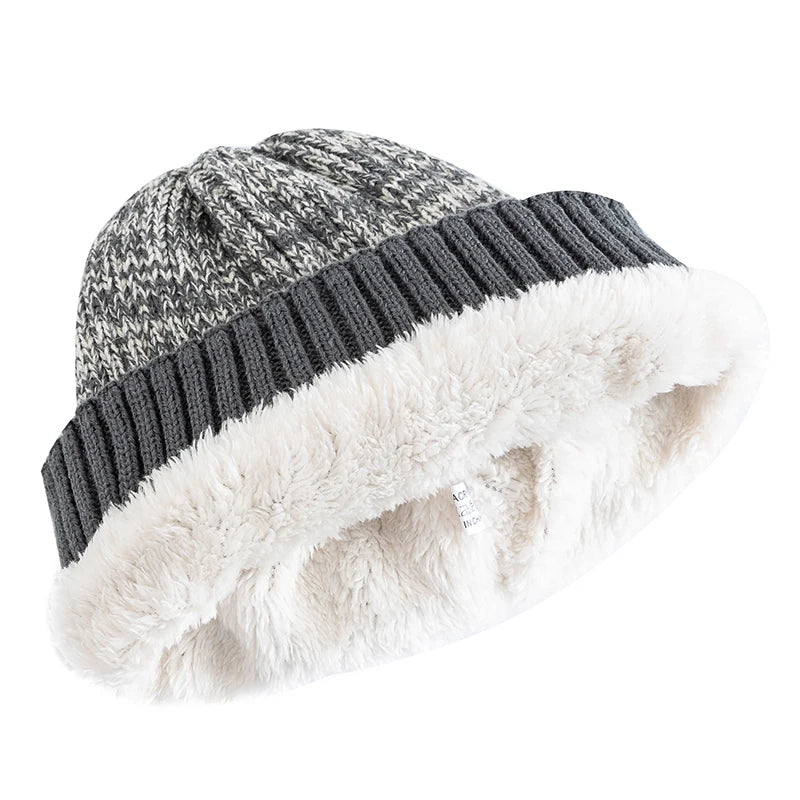 Knitted beanie with gray and white pattern and white fur lining on a white background