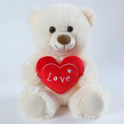White teddy bear with a red heart that says 'Love' on a white background