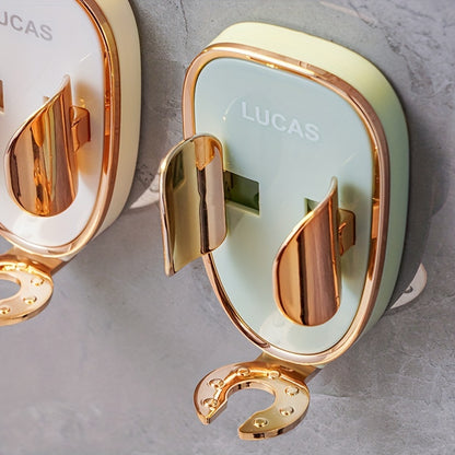 Gold and white cosmetic compact with 'Lucas' branding on a gray surface