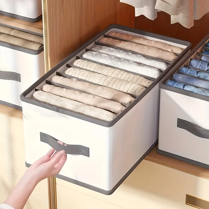 Storage box with rolled-up clothes on a wooden shelf