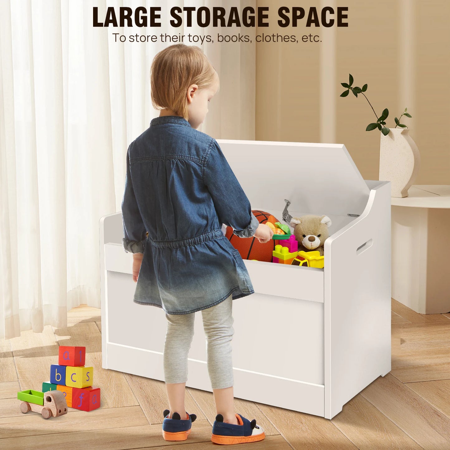 Child standing next to a white toy storage unit with colorful toys on a wooden floor.