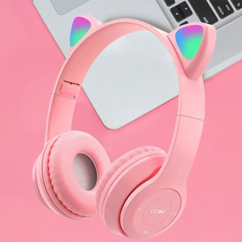 Pink headphones with cat ear design on a pink background