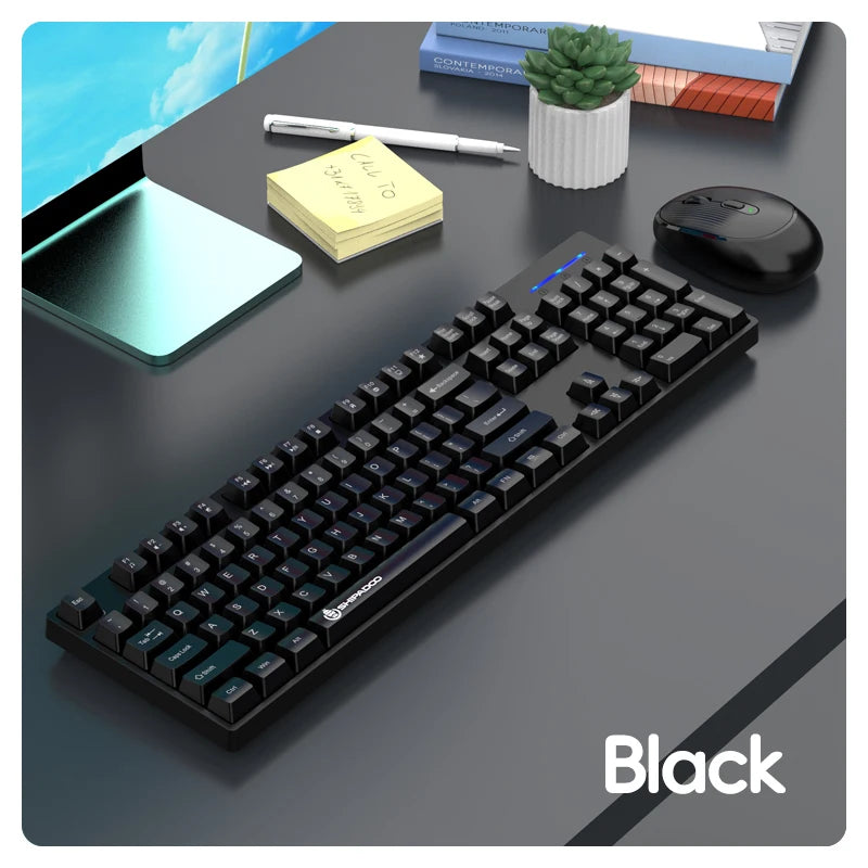 Black keyboard on a desk with a tablet, pen, and plant