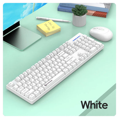 White keyboard on a desk with a tablet, mouse, and stationery items.