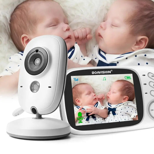 Two babies holding hands with a BOAVISION baby monitor displaying their video feed.