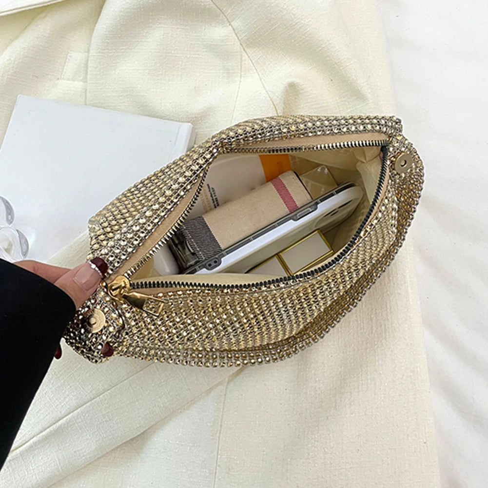 Gold beaded clutch bag with a hand holding it open on a white surface