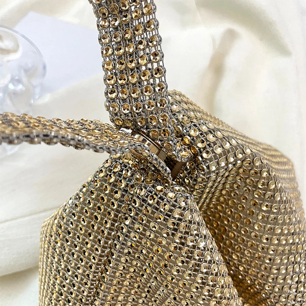 Gold rhinestone handbag on a white background