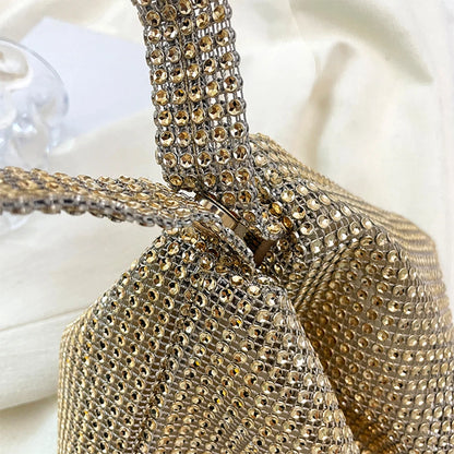 Gold rhinestone handbag on a white background