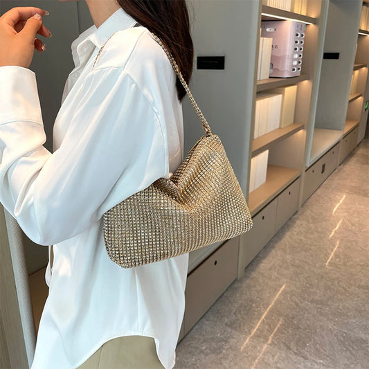 Person holding a sparkling handbag in an indoor setting