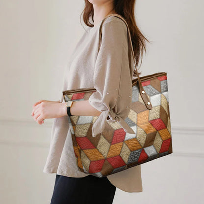 Person holding a multicolored geometric-patterned handbag against a neutral background