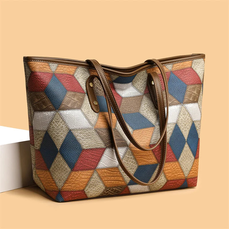 Multicolored geometric patterned handbag with brown handles on a beige background