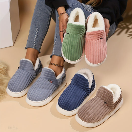 Four pairs of colorful slippers on a beige surface
