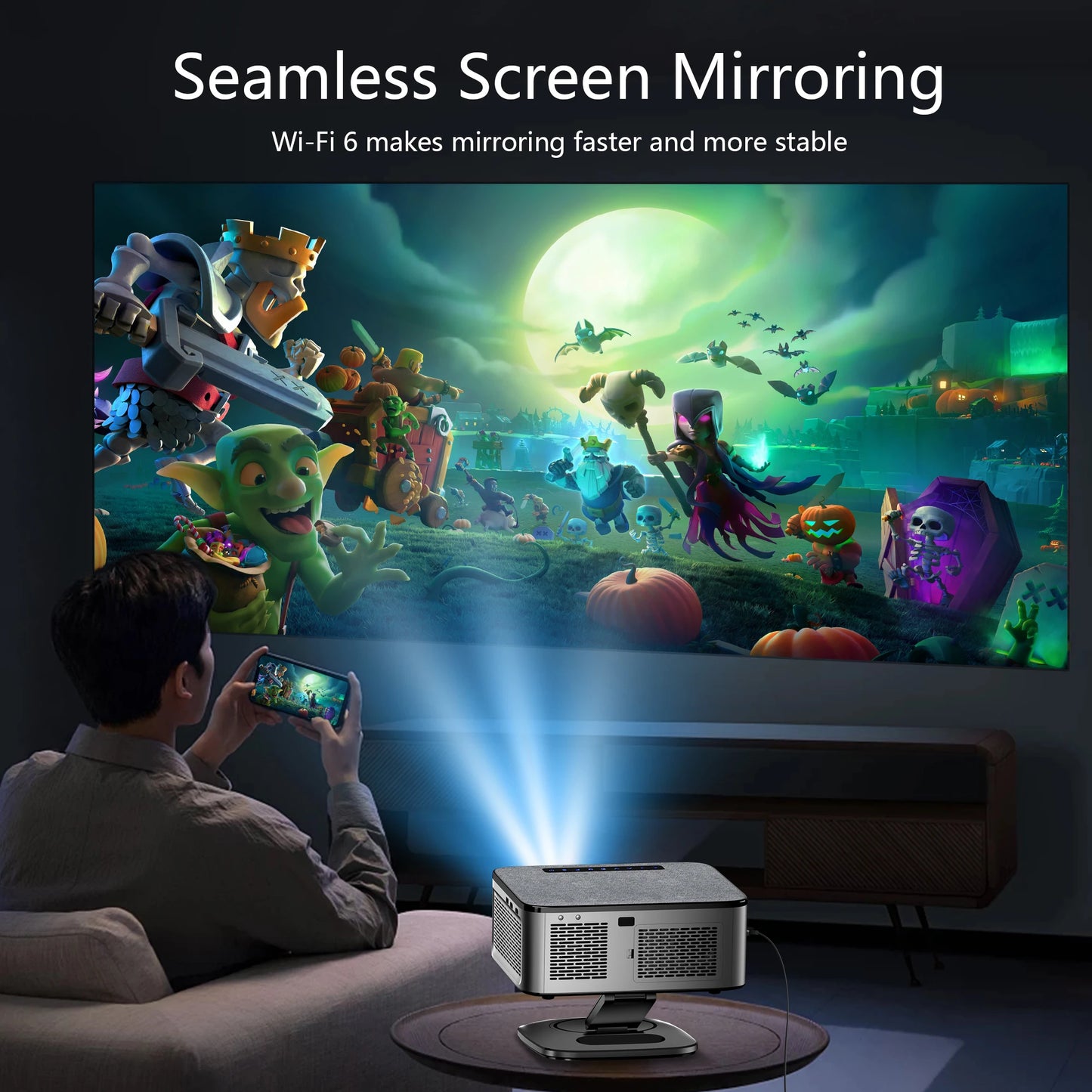 Person using a smartphone to project a colorful animated scene onto a screen with a projector.