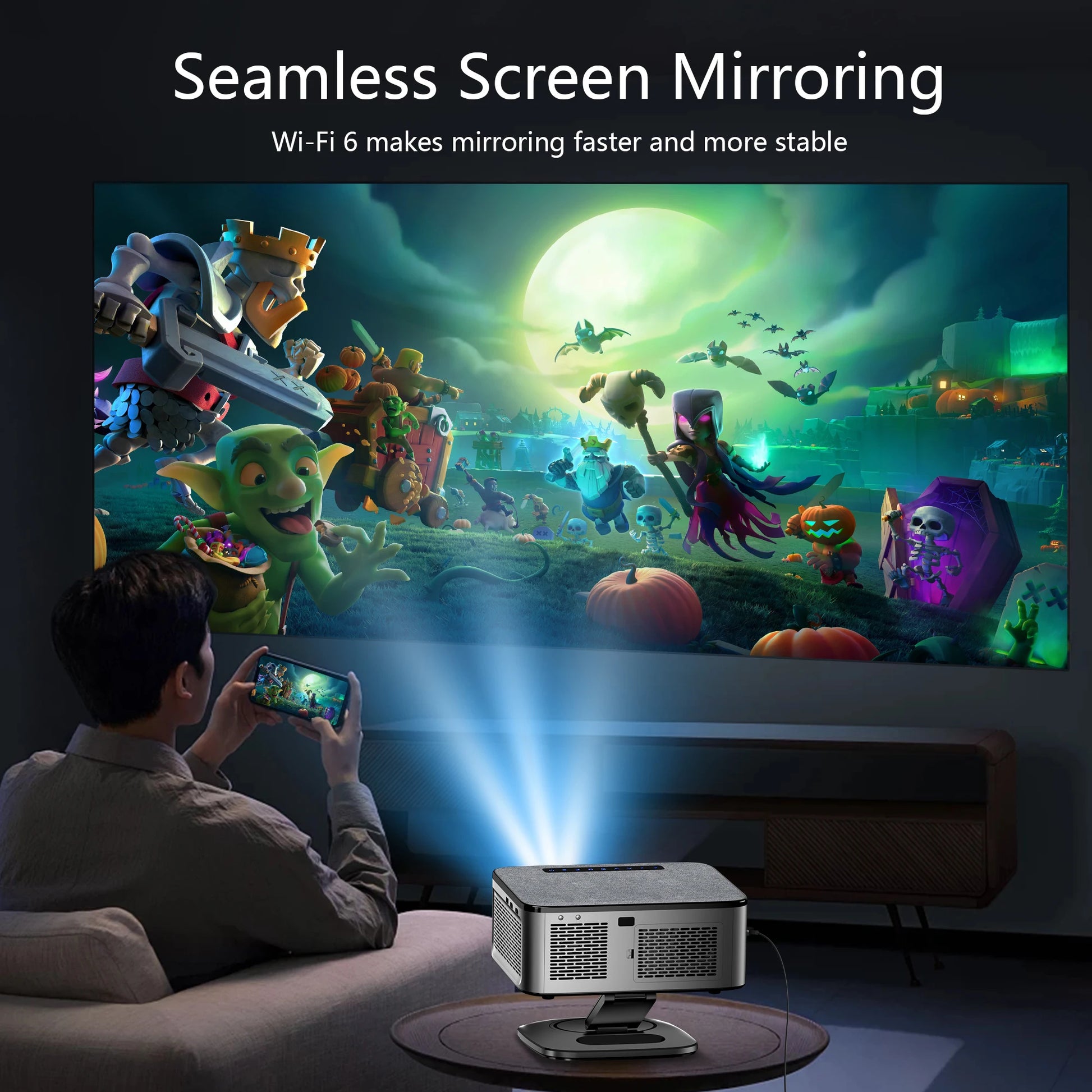 Person using a smartphone to project a colorful animated scene onto a screen with a projector.